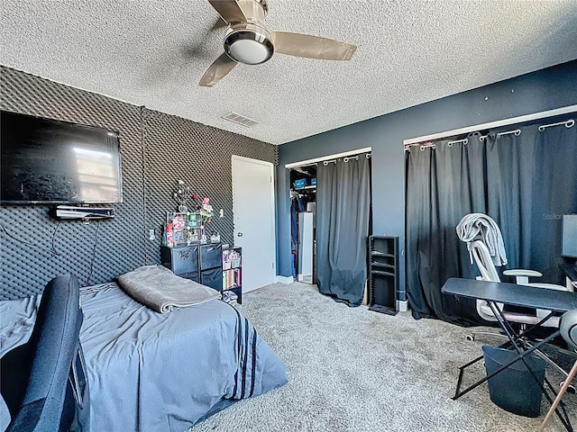 bedroom featuring carpet floors, ceiling fan, and a textured ceiling