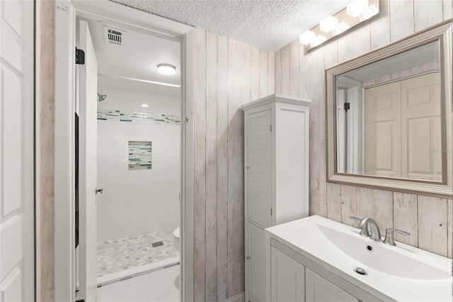 3475 Flossmoor Ave Unit 103, Orlando, FL 32822 - full bathroom with a shower stall, a textured ceiling, vanity, wooden walls, and toilet
