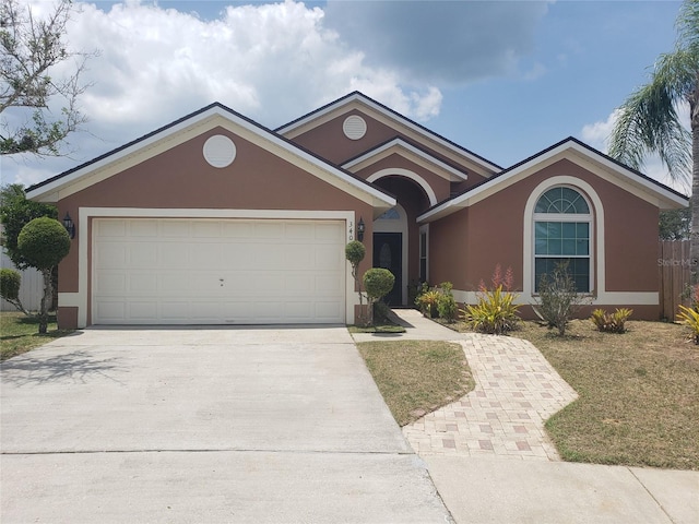 340 Haversham Way, Davenport, FL 33897 - single story home with driveway, stucco siding, and a garage