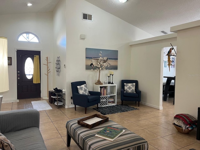 340 Haversham Way, Davenport, FL 33897 - tiled living area with high vaulted ceiling, a textured ceiling, and baseboards