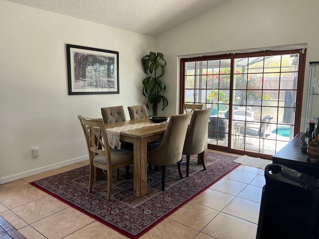 340 Haversham Way, Davenport, FL 33897 - dining room with light tile patterned floors, a textured ceiling, baseboards, and lofted ceiling