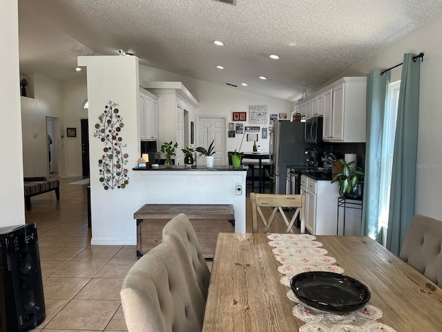 340 Haversham Way, Davenport, FL 33897 - dining room with a textured ceiling, vaulted ceiling, light tile patterned floors, and recessed lighting