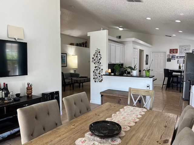 340 Haversham Way, Davenport, FL 33897 - dining area with vaulted ceiling, a textured ceiling, light tile patterned floors, and recessed lighting