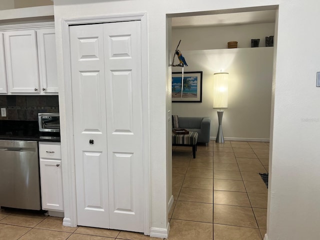 340 Haversham Way, Davenport, FL 33897 - kitchen with dishwasher, light tile patterned floors, white cabinetry, dark countertops, and baseboards