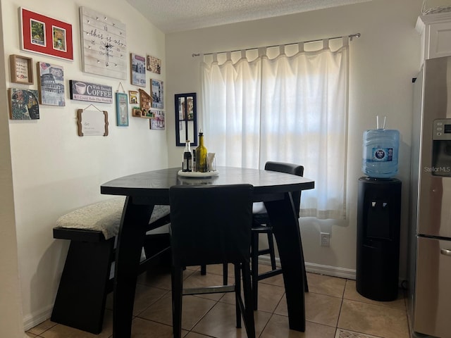 340 Haversham Way, Davenport, FL 33897 - dining space featuring light tile patterned floors, baseboards, and a textured ceiling