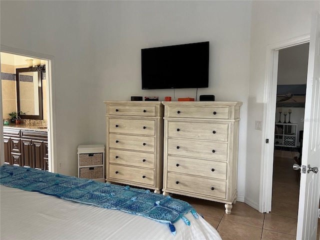 340 Haversham Way, Davenport, FL 33897 - bedroom featuring dark tile patterned floors, baseboards, and ensuite bath