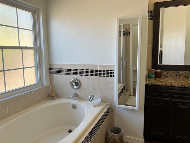 340 Haversham Way, Davenport, FL 33897 - full bathroom featuring healthy amount of natural light, a garden tub, vanity, and a stall shower