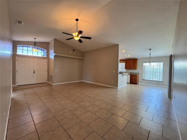 703 Tartan Loop, Lake Wales, FL 33853 - unfurnished living room featuring light tile patterned floors, vaulted ceiling, ceiling fan, baseboards, and a chandelier