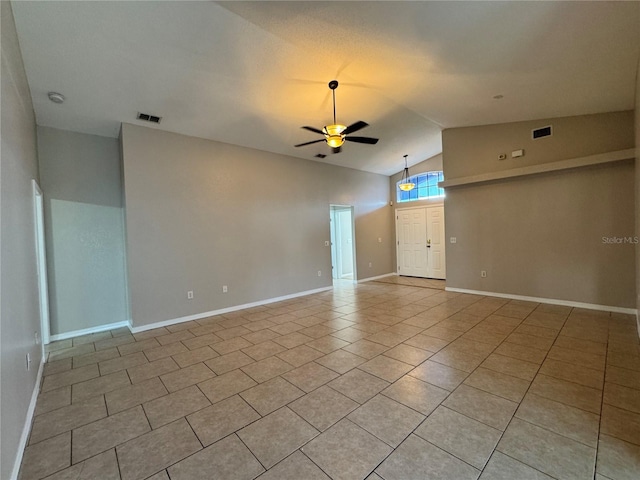 703 Tartan Loop, Lake Wales, FL 33853 - empty room featuring ceiling fan, vaulted ceiling, light tile patterned floors, baseboards, and a smoke detector