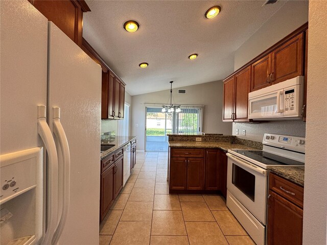 703 Tartan Loop, Lake Wales, FL 33853 - kitchen featuring white appliances, vaulted ceiling, a peninsula, recessed lighting, and decorative light fixtures