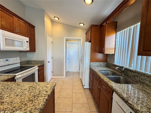 703 Tartan Loop, Lake Wales, FL 33853 - kitchen featuring white appliances, a sink, stone counters, light tile patterned flooring, and baseboards