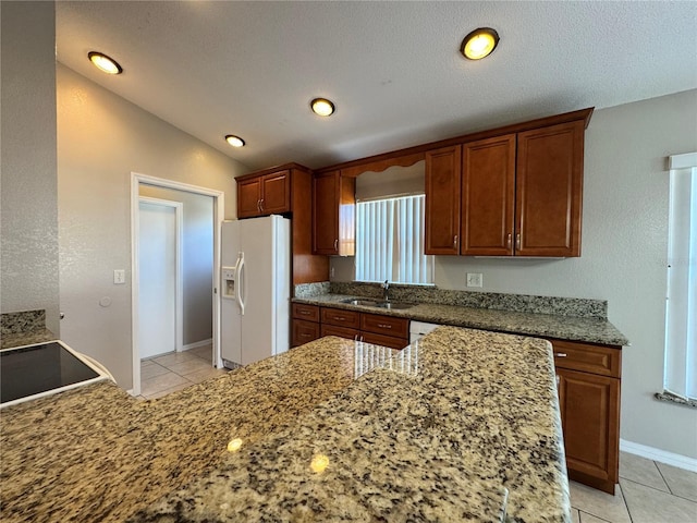 703 Tartan Loop, Lake Wales, FL 33853 - kitchen with white refrigerator with ice dispenser, a sink, light tile patterned floors, light stone counters, and lofted ceiling