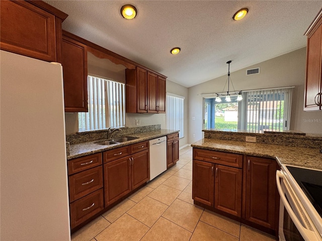 703 Tartan Loop, Lake Wales, FL 33853 - kitchen featuring white appliances, a sink, vaulted ceiling, light tile patterned flooring, and a textured ceiling