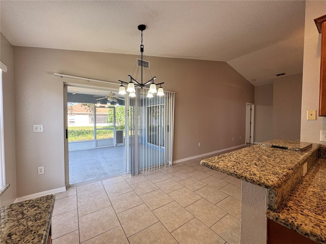 703 Tartan Loop, Lake Wales, FL 33853 - unfurnished dining area featuring a chandelier, light tile patterned flooring, lofted ceiling, and baseboards