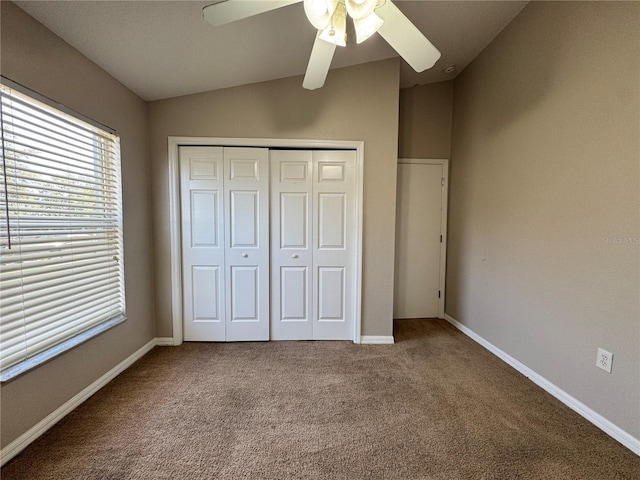 703 Tartan Loop, Lake Wales, FL 33853 - unfurnished bedroom with carpet floors, a closet, vaulted ceiling, baseboards, and a ceiling fan