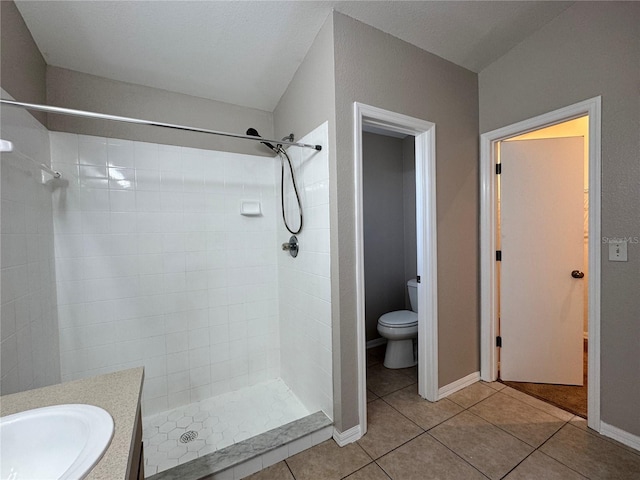703 Tartan Loop, Lake Wales, FL 33853 - bathroom featuring toilet, tile patterned flooring, tiled shower, vanity, and baseboards