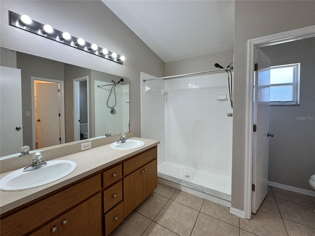 703 Tartan Loop, Lake Wales, FL 33853 - bathroom with toilet, tiled shower, double vanity, and tile patterned floors