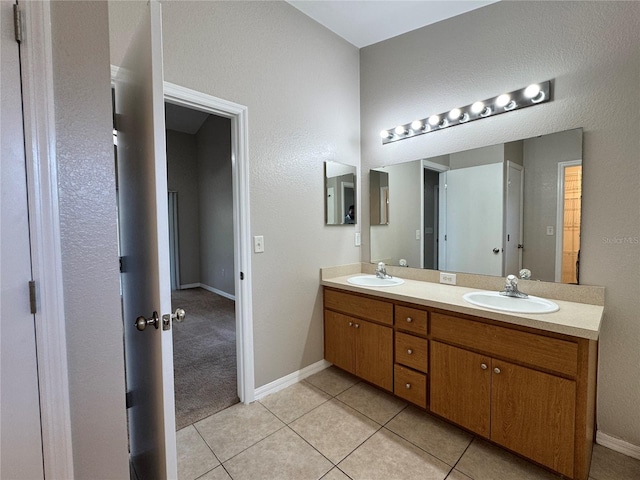 703 Tartan Loop, Lake Wales, FL 33853 - bathroom with double vanity, tile patterned flooring, and baseboards