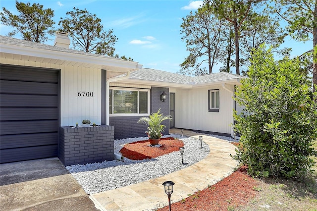 6700 Tamarind Cir, Orlando, FL 32819 - view of front of property with a chimney and a shingled roof