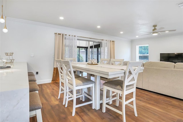 6700 Tamarind Cir, Orlando, FL 32819 - dining space featuring crown molding, wood finished floors, baseboards, ceiling fan, and recessed lighting