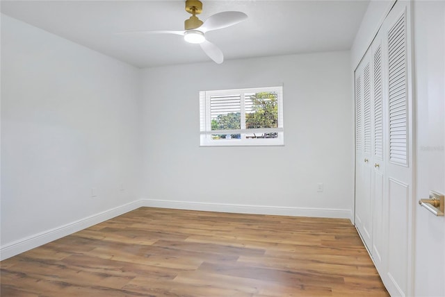 6700 Tamarind Cir, Orlando, FL 32819 - unfurnished bedroom with a closet, wood finished floors, baseboards, and a ceiling fan