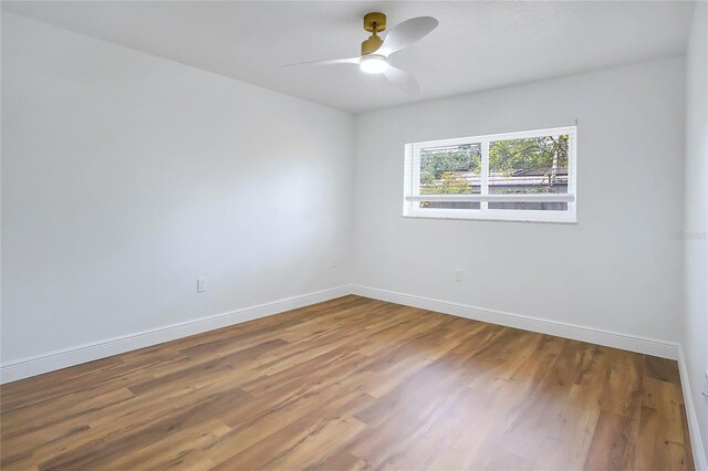 6700 Tamarind Cir, Orlando, FL 32819 - unfurnished room featuring baseboards, wood finished floors, and ceiling fan