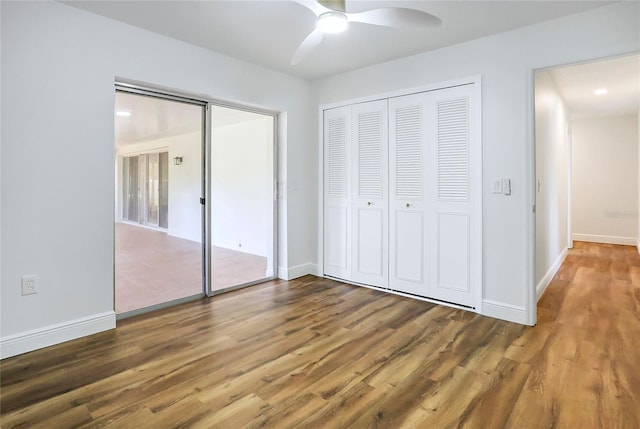 6700 Tamarind Cir, Orlando, FL 32819 - unfurnished bedroom featuring wood finished floors, baseboards, and a ceiling fan