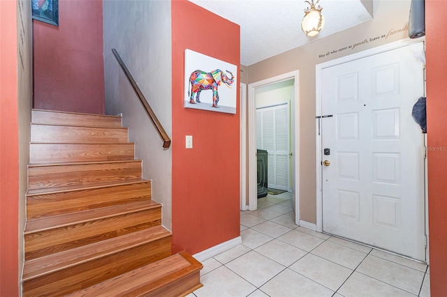 109 Lakepointe Cir, Kissimmee, FL 34743 - entryway with light tile patterned flooring, baseboards, and stairway