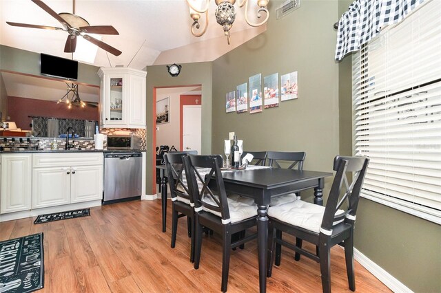 109 Lakepointe Cir, Kissimmee, FL 34743 - dining room with a ceiling fan, light wood-style floors, a chandelier, baseboards, and lofted ceiling
