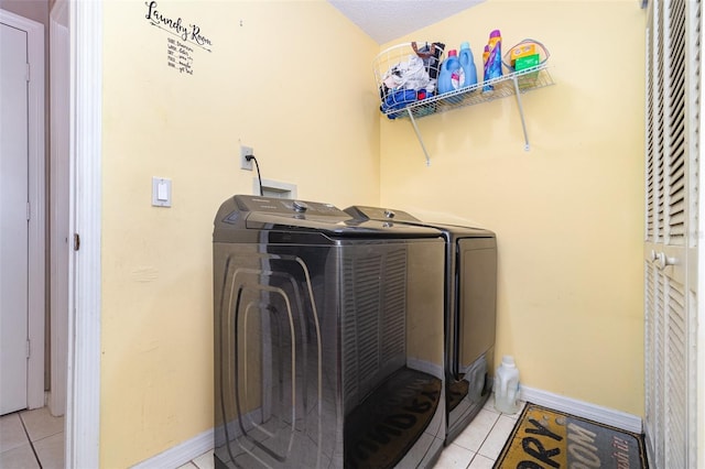 109 Lakepointe Cir, Kissimmee, FL 34743 - laundry area featuring washer and dryer, light tile patterned floors, and baseboards
