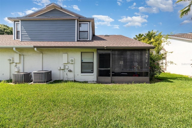 109 Lakepointe Cir, Kissimmee, FL 34743 - back of house featuring central AC, a lawn, roof with shingles, and a sunroom