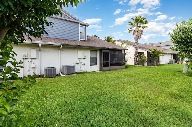 109 Lakepointe Cir, Kissimmee, FL 34743 - rear view of property with central air condition unit, a yard, and a sunroom