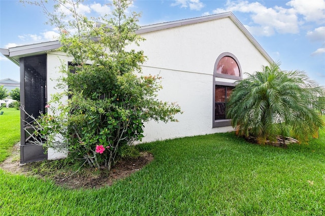 109 Lakepointe Cir, Kissimmee, FL 34743 - view of property exterior with stucco siding and a yard