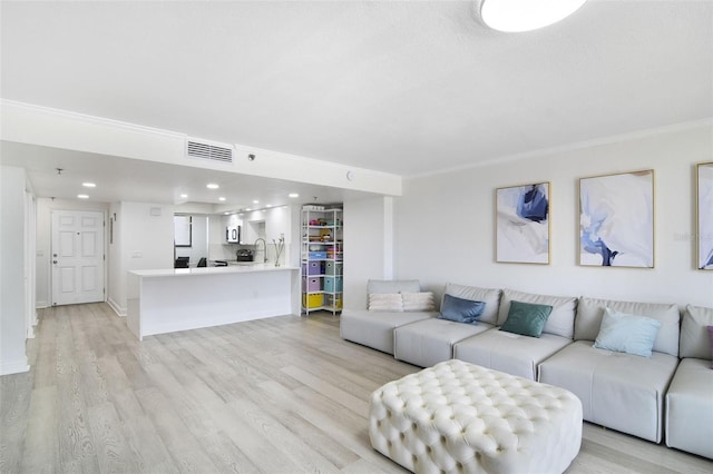 530 E Central Blvd Unit 803, Orlando, FL 32801 - living area featuring light wood finished floors, ornamental molding, and recessed lighting