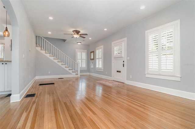 338 E Anderson St, Orlando, FL 32801 - entrance foyer featuring stairway, a ceiling fan, light wood finished floors, arched walkways, and baseboards