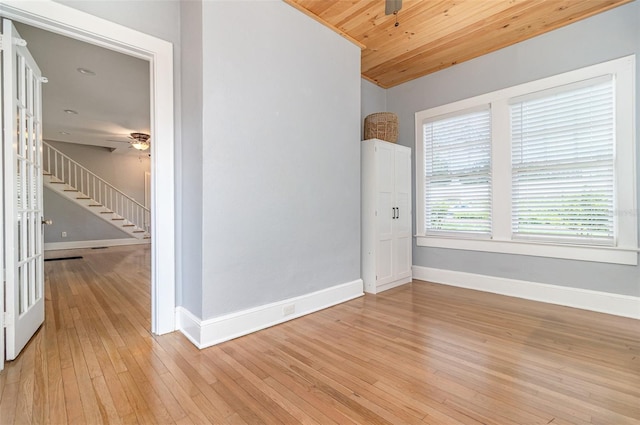 338 E Anderson St, Orlando, FL 32801 - unfurnished room featuring a ceiling fan, baseboards, light wood finished floors, stairway, and wooden ceiling