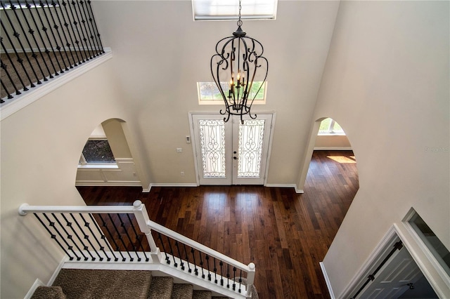 1201 Shelter Rock Rd, Orlando, FL 32835 - foyer with a high ceiling, a chandelier, stairs, wood finished floors, and arched walkways