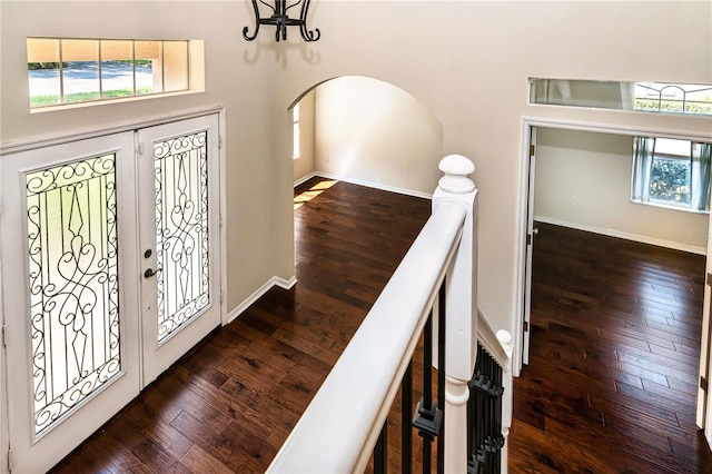 1201 Shelter Rock Rd, Orlando, FL 32835 - foyer with wood-type flooring, arched walkways, baseboards, a chandelier, and a high ceiling