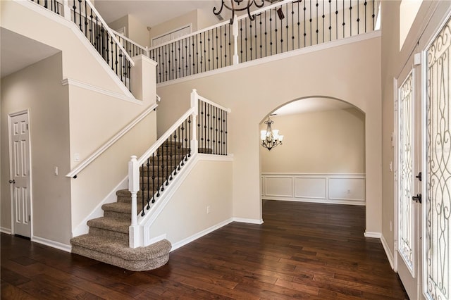 1201 Shelter Rock Rd, Orlando, FL 32835 - foyer with a towering ceiling, a chandelier, hardwood / wood-style flooring, arched walkways, and stairway