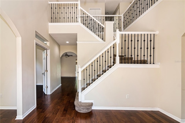1201 Shelter Rock Rd, Orlando, FL 32835 - stairs featuring a high ceiling, arched walkways, wood-type flooring, a ceiling fan, and baseboards