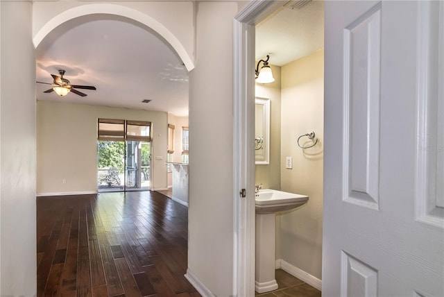 1201 Shelter Rock Rd, Orlando, FL 32835 - hall featuring baseboards, dark wood-style flooring, and arched walkways