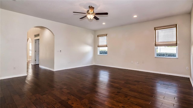 1201 Shelter Rock Rd, Orlando, FL 32835 - empty room with ceiling fan, arched walkways, dark wood-style floors, baseboards, and recessed lighting
