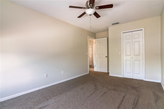 1201 Shelter Rock Rd, Orlando, FL 32835 - unfurnished bedroom featuring baseboards, dark colored carpet, a closet, and a ceiling fan