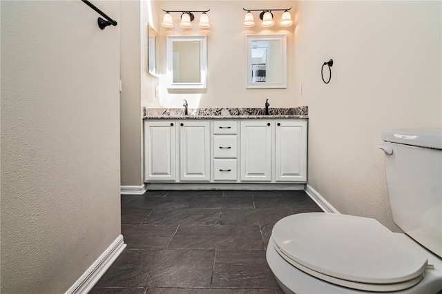 1201 Shelter Rock Rd, Orlando, FL 32835 - bathroom with toilet, baseboards, and double vanity