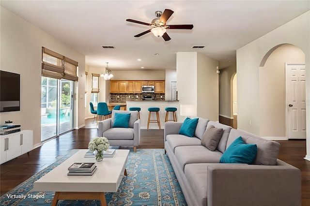 1201 Shelter Rock Rd, Orlando, FL 32835 - living area with arched walkways, a ceiling fan, dark wood-style flooring, a chandelier, and recessed lighting