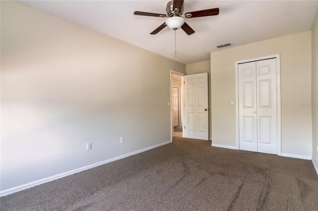 1201 Shelter Rock Rd, Orlando, FL 32835 - unfurnished bedroom featuring dark carpet, a closet, and ceiling fan