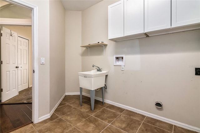 1201 Shelter Rock Rd, Orlando, FL 32835 - washroom with cabinet space, hookup for a washing machine, and dark tile patterned floors