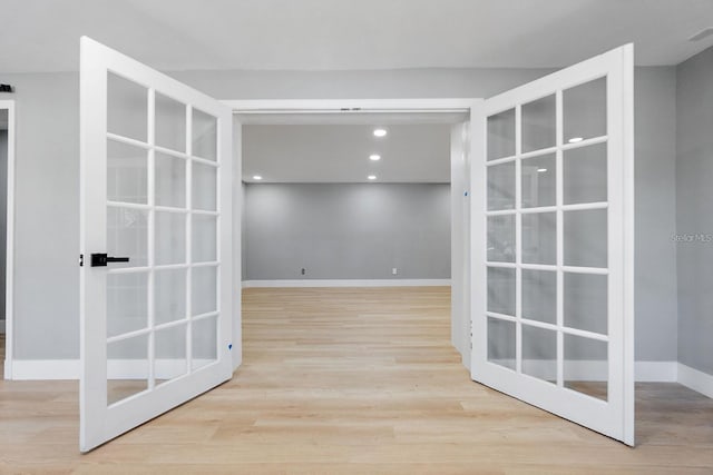 3926 Helena St NE, Saint Petersburg, FL 33703 - hallway featuring wood finished floors, baseboards, recessed lighting, and french doors