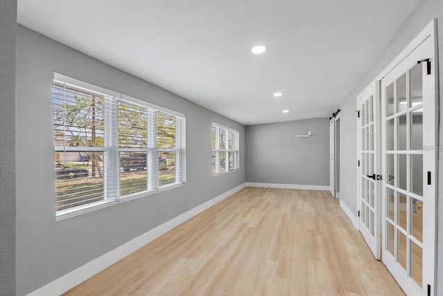 3926 Helena St NE, Saint Petersburg, FL 33703 - spare room with wood finished floors, recessed lighting, baseboards, and french doors