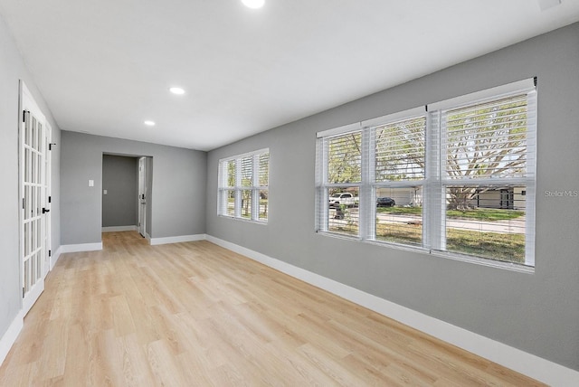 3926 Helena St NE, Saint Petersburg, FL 33703 - spare room with baseboards, recessed lighting, light wood-type flooring, and french doors
